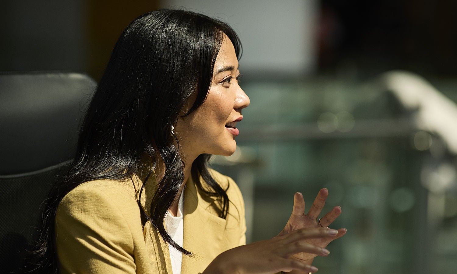 A professional woman holding a conversation in an office.